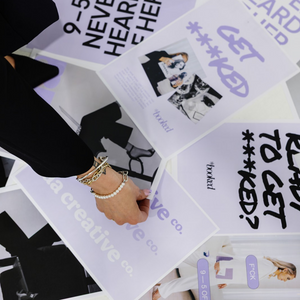 Hand holding a card with text and a graphic design, surrounded by similar cards.