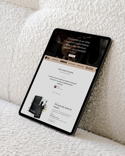 Tablet displaying a website on a white textured surface