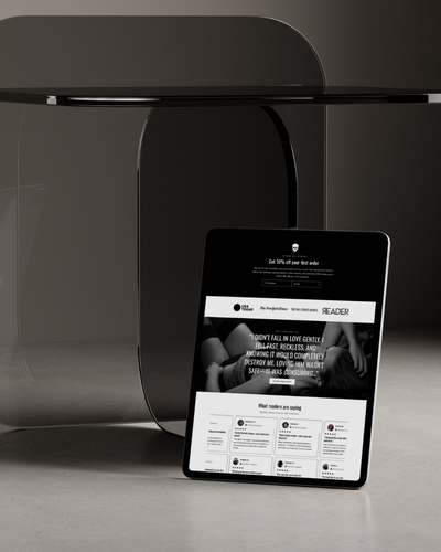 Tablet displaying a website on a dark surface with a modern black table in the background