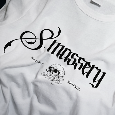 White t-shirt with black graphic design and text on a white background