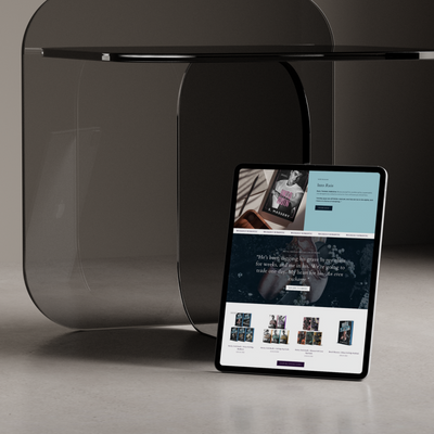 Tablet displaying a website on a dark glass table