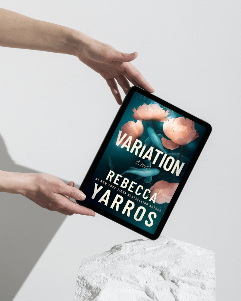 Digital tablet displaying the book cover of 'Variation' by Rebecca Yarros held by two hands against a light background.