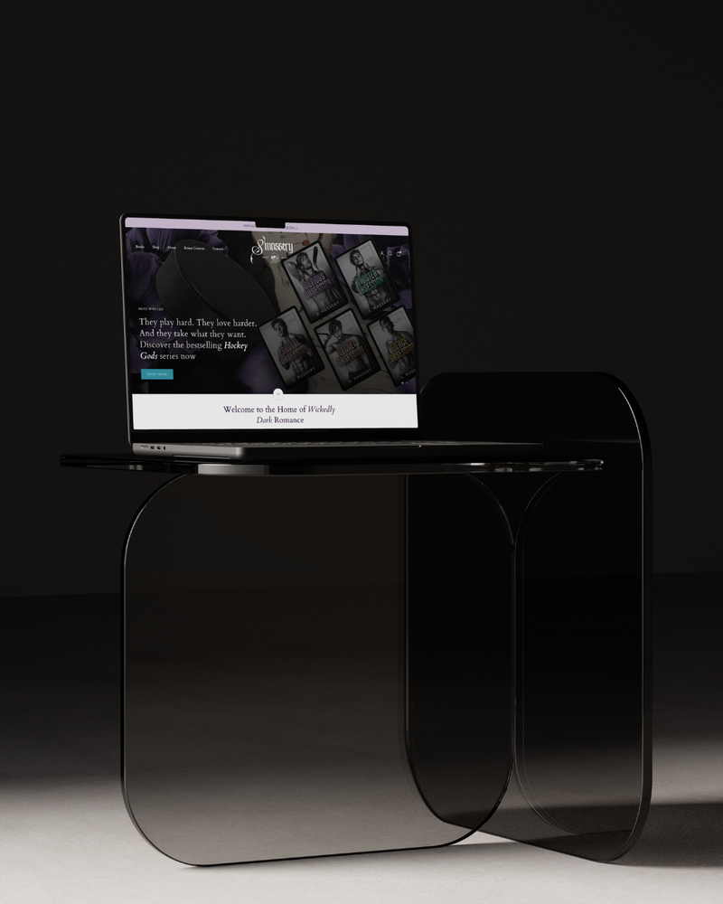 Modern glass side table with a laptop on a dark background